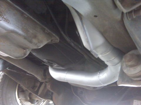 1994 Ford F-150 - The exhaust system of a 1994 Ford F-150 is visible from underneath.