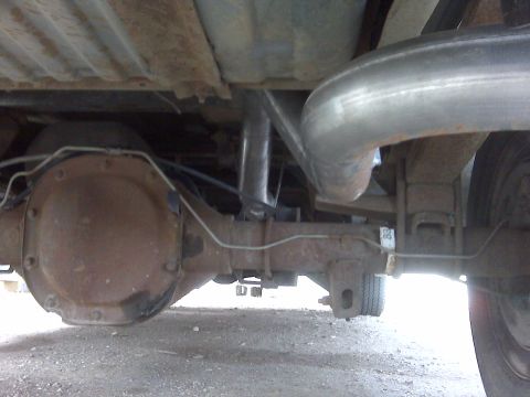 1994 Ford F-150 - Close-up view of the undercarriage of a truck, focusing on the rear axle and exhaust system.