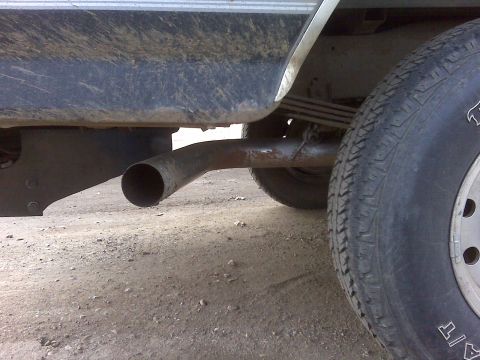 1994 Ford F-150 - The side profile of a 1994 Ford F-150 shows its exhaust system and rear wheel.