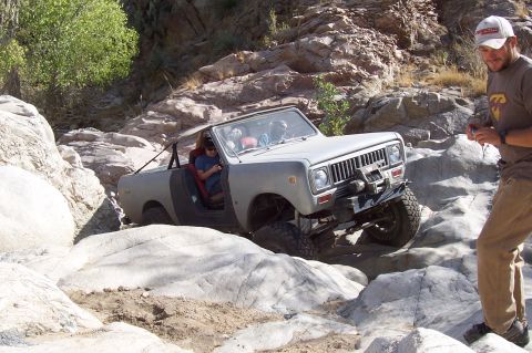 1981 Ford F-150 - An International Scout II navigates a rocky terrain, demonstrating its off-road capabilities.