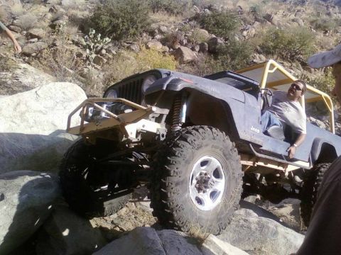 1981 Ford F-150 - A heavily modified Jeep Wrangler navigates a rocky trail, its off-road capabilities.