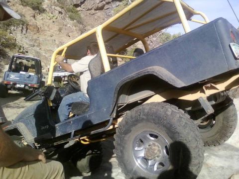 1981 Ford F-150 - Two off-road vehicles navigate a rocky trail, with a Jeep in the foreground and a Suzuki Samurai in the background.