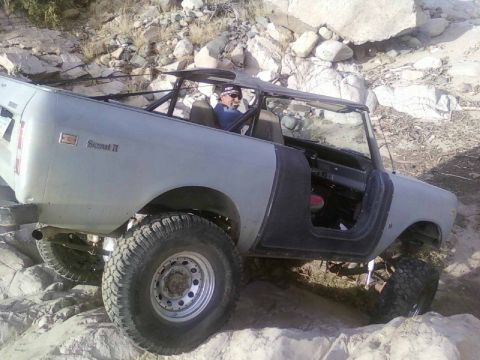 1981 Ford F-150 - This off-road vehicle navigates a challenging rocky landscape with its doors removed.