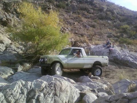 1981 Ford F-150 - This lifted pickup truck is shown off-roading on a rocky hillside.