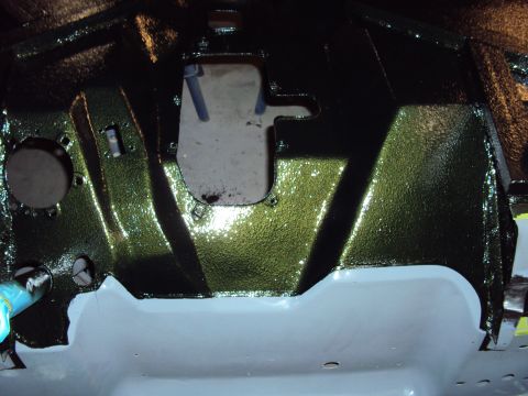 1948 Jeep Wrangler - Undercarriage of a vehicle, painted green with gray primer, shows a large opening.