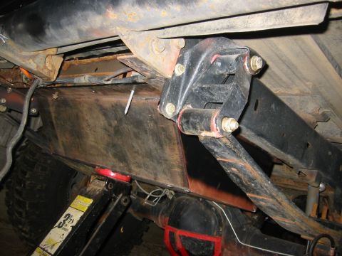1995 Ford Bronco - Vehicle undercarriage showing fuel tank and suspension components, with jacks supporting the frame.