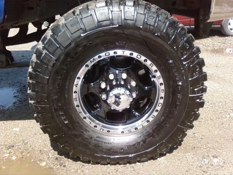 1997 Ford F-350 - Close-up of a large truck tire and wheel, with part of the vehicle's frame visible.