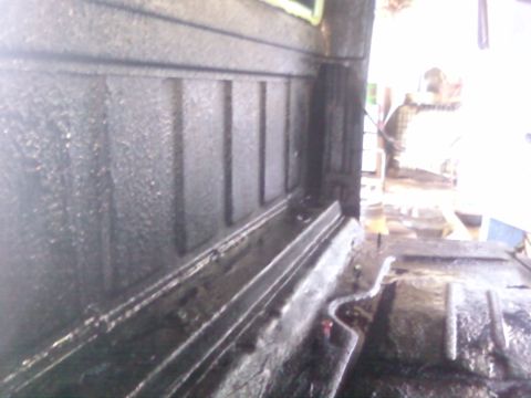 1997 Ford F-350 - Close-up view of the interior of a truck bed, highlighting its textured surfaces.