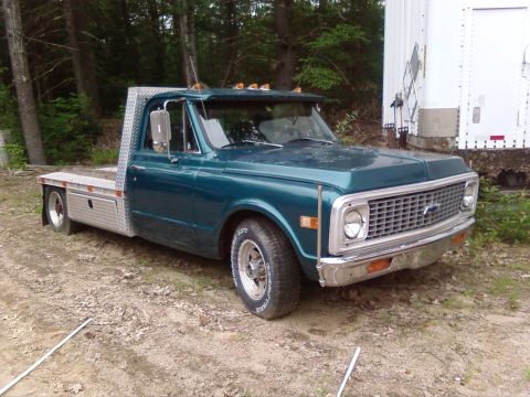 1997 Ford F-350 - This teal flatbed truck appears to be from the early 1970s, not a 1997 model.
