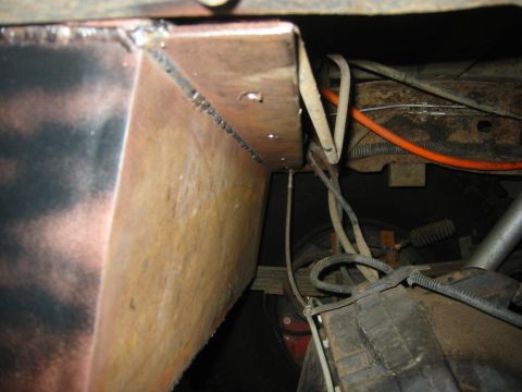 1995 Ford Bronco - Close-up view of a custom welded metal bracket on a vehicle's undercarriage.