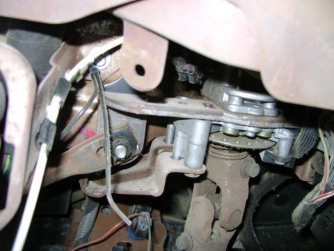 1998 Ford Crown Victoria - Underside view of vehicle's steering column and brake pedal mechanism, showing various components and wiring.