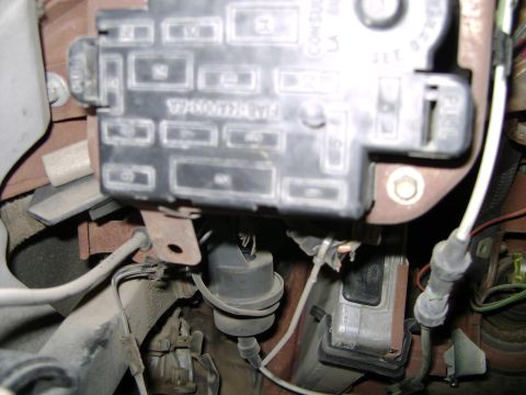 1998 Ford Crown Victoria - Close-up view of a vehicle's interior fuse box and associated electrical components.