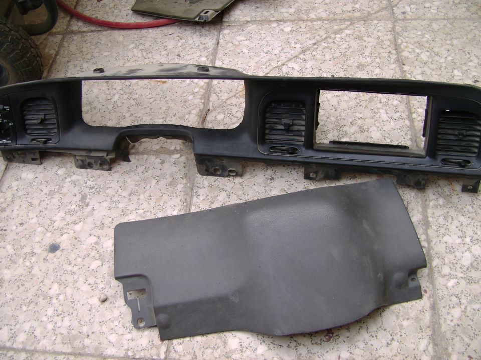 Dashboard instrument panel and a lower dash trim piece removed from a vehicle