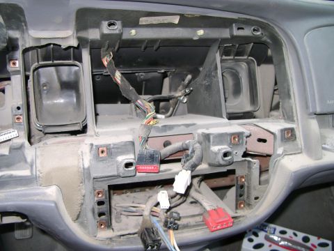 1998 Ford Crown Victoria - Exposed dashboard wiring harness with dust and disconnected electrical connectors.