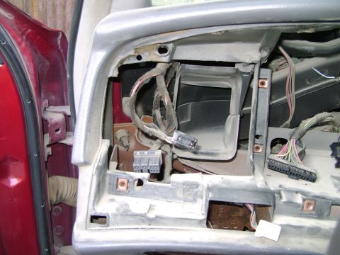 1998 Ford Crown Victoria - The dashboard of a 1998 Ford Crown Victoria is disassembled, revealing wiring and internal components.