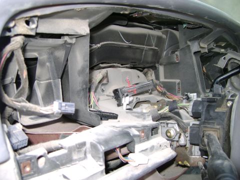 1998 Ford Crown Victoria - Close-up view of the dashboard wiring and internal components of a 1998 Ford Crown Victoria, likely during cleaning or repair.