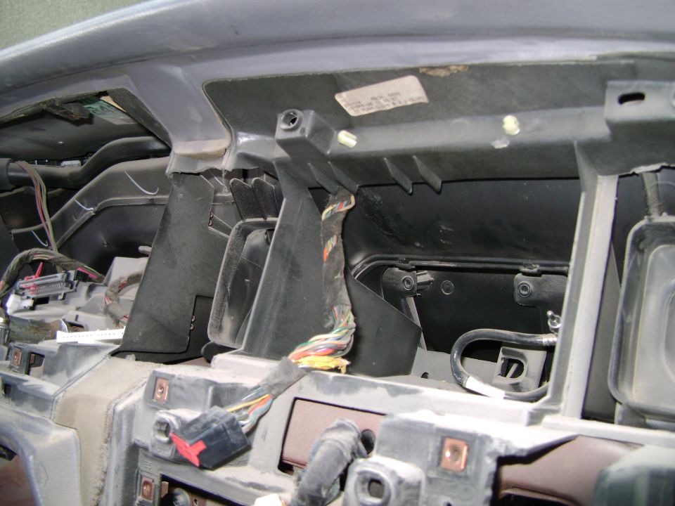 Dashboard disassembled, showing wiring harnesses and internal components