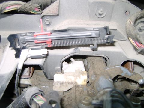 1998 Ford Crown Victoria - Close-up view of an interior mechanical assembly, likely part of the dashboard or steering column, showing springs and wiring.