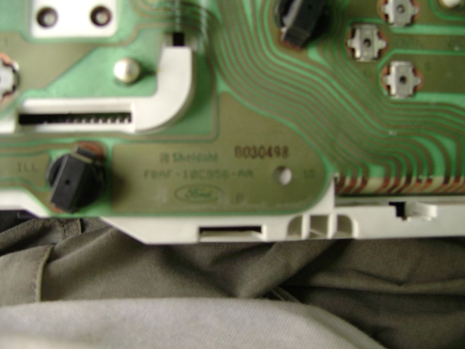 Close-up of a Ford instrument cluster circuit board with part numbers visible