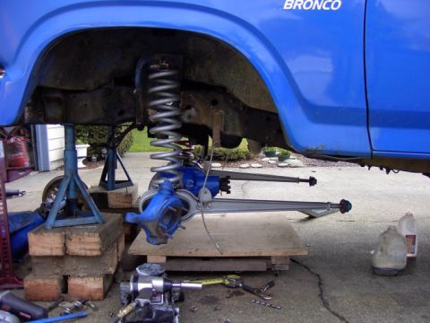 1980 Ford Bronco - A blue 1980 Ford Bronco is shown with its front suspension removed for repair.