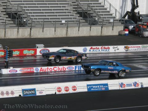 1968 Ford Mustang - Two muscle cars compete during a drag race event at Auto Club Raceway.