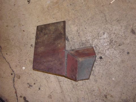 1980 Ford Bronco - A metal bracket is shown on a concrete surface.