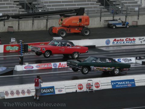 1968 Ford Mustang - Two cars compete in a drag race, with the green car appearing to be a 1968 Plymouth Barracuda and the red car a 1968 Dodge Coronet.