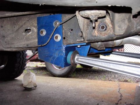 1980 Ford Bronco - Custom blue suspension bracket and metal arm are visible on the underside of a vehicle.