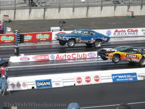 1968 Ford Mustang - Two drag cars compete on a sunny day at Auto Club Raceway.