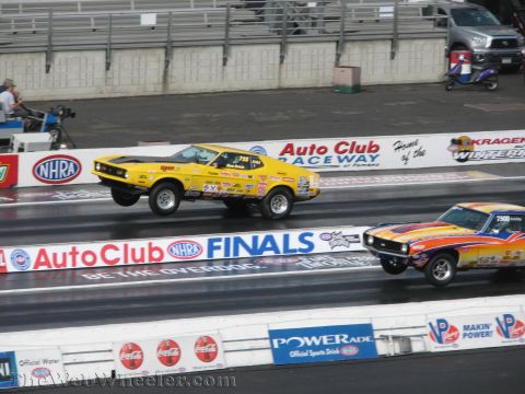 1968 Ford Mustang - Two drag cars compete on a track during the NHRA Finals.