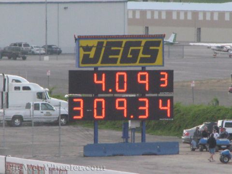 1968 Ford Mustang - A JEGS scoreboard shows race times at a drag strip, with trucks and airplanes visible in the background.
