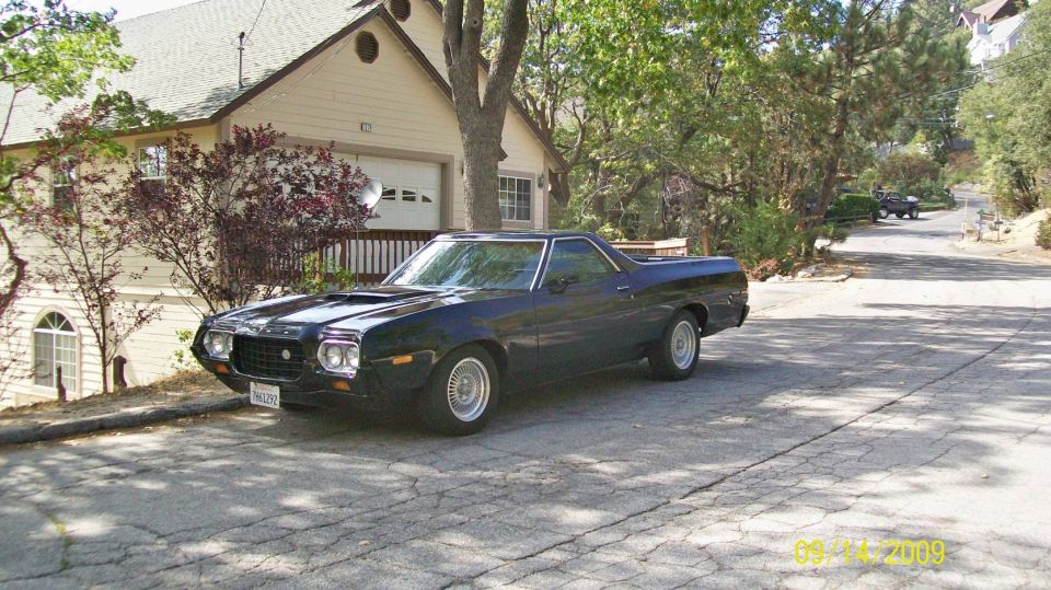 Dark blue 1972 Ford Ranchero parked on a residential street, front 3/4 view