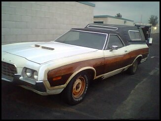 1972 Ford Ranchero - This 1972 Ford Ranchero pickup truck features a two-tone paint scheme with woodgrain trim and a camper shell.