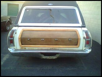 1972 Ford Ranchero - Rear view of a white 1972 Ford Ranchero pickup truck a woodgrain tailgate panel.