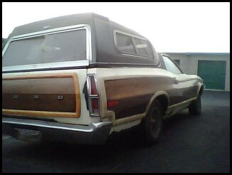 1972 Ford Ranchero - Rear view of a 1972 Ford Ranchero wood paneling and a camper shell. The vehicle appears to be in good condition.