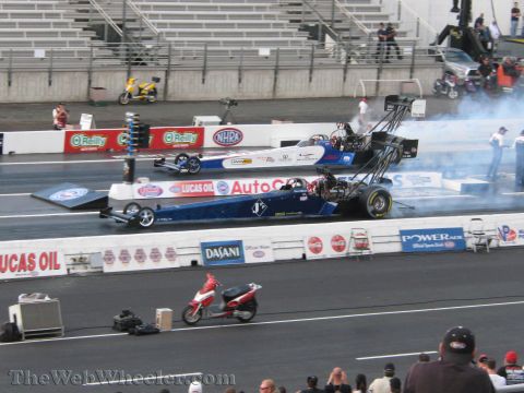 1968 Ford Mustang - Two dragsters compete side-by-side during qualifying at the 2009 NHRA Finals.