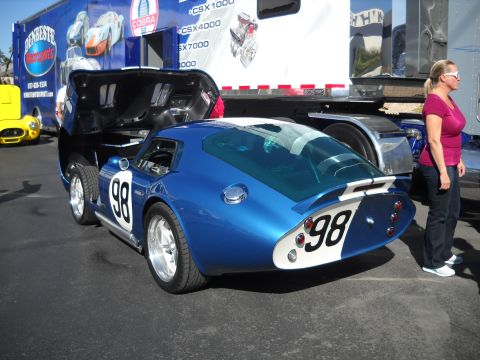 1986 Ford Bronco II - A blue race car with white racing stripes and the number 98 is parked with its hood open.