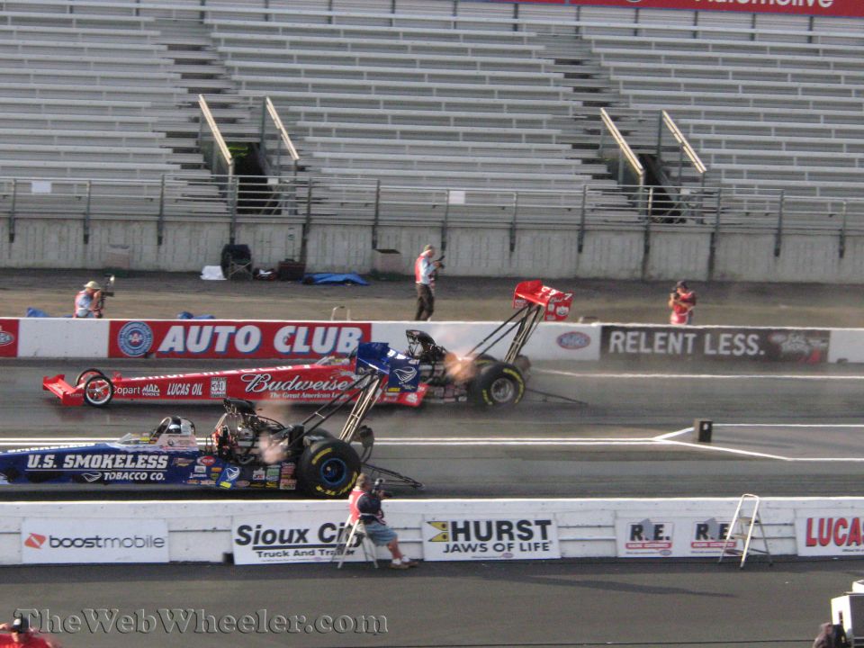 two drag cars racing, one with Budweiser sponsorship, the other with U.S. Smokeless Tobacco sponsorship