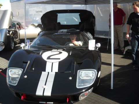 1986 Ford Bronco II - A black race car with racing stripes and the number 2 is parked under a tent, with people standing nearby.