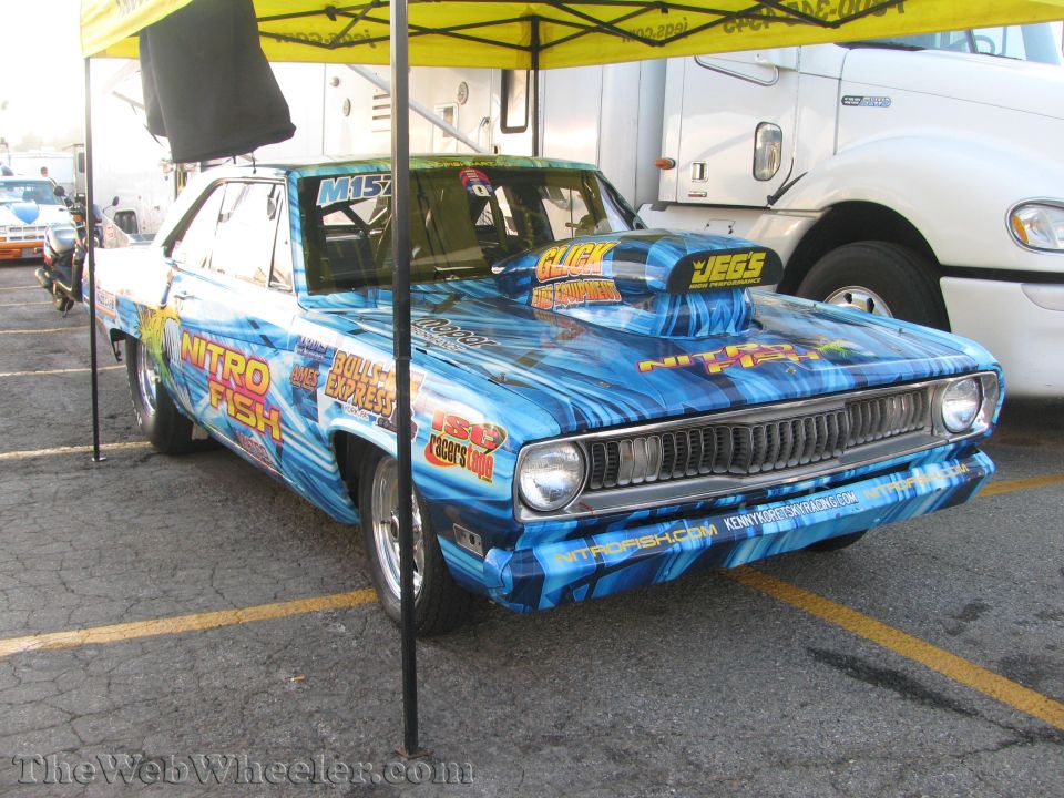 Blue drag car with "Nitro Fish" graphics, large hood scoop, and racing slicks