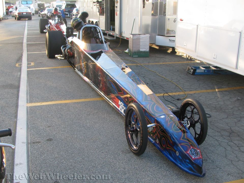 Dragster with blue and red flame graphics, front view