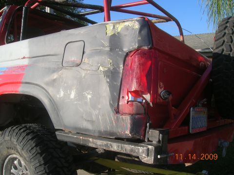 1985 Ford Bronco - The rear of a 1985 Ford Bronco shows significant body damage and a custom roll cage, with a date stamp of 11.14.2009.