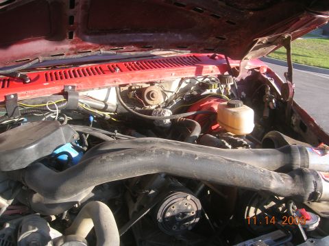 1985 Ford Bronco - Close-up view of a vehicle's engine bay, showing various mechanical parts and wiring.