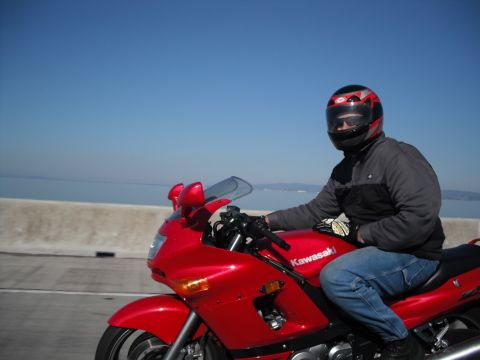 1991 Ford Bronco - Riding a red Kawasaki motorcycle on a sunny day with a clear blue sky and water in the background.