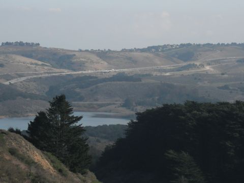 1991 Ford Bronco - A scenic view of rolling hills, a lake, and a distant highway.
