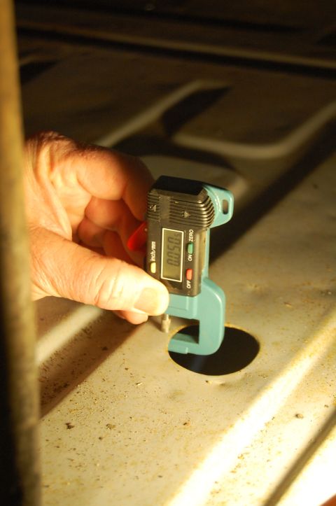 1963 Ford Galaxie - A digital caliper is used to measure the thickness of a metal surface, showing 0.050 inches.