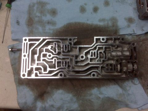 1994 Ford F-150 - A disassembled valve body, a complex component of an automatic transmission, is shown on a stained towel.