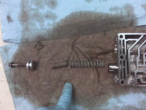 1994 Ford F-150 - Transmission valve body components laid out on a towel, including springs and a plunger.