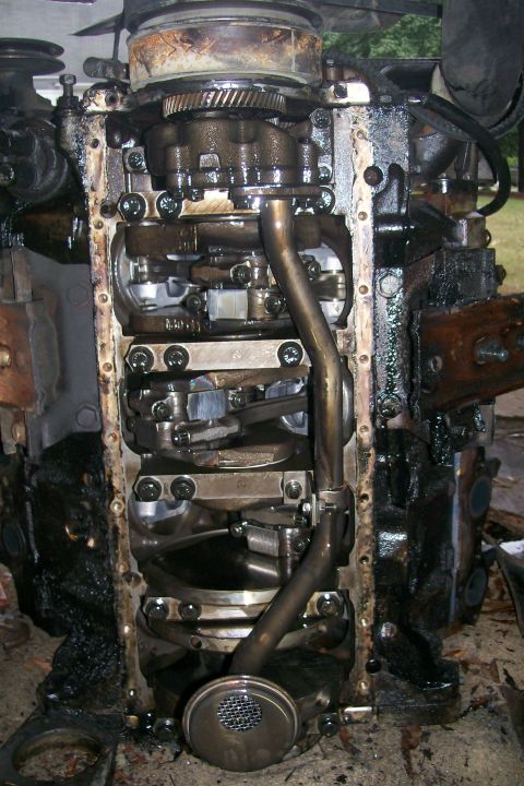 1992 Ford C-350 (Centurion Conversions) - Close-up of an engine's internal components, including the crankshaft and oil pan assembly.