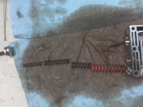 1994 Ford F-150 - Disassembled transmission parts, including springs and a valve body, are shown on a stained shop towel.